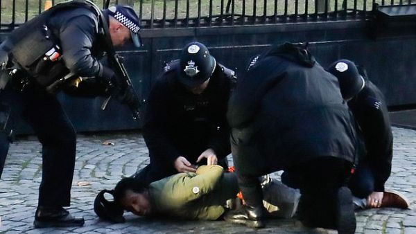 The man was later pinned down to the ground while armed officers surrounded him, with one pointing a gun at his head. (AFP/File)