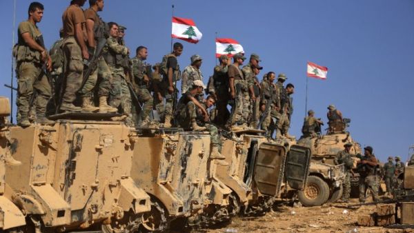Lebanese soldiers stand on armoured vehicles on a hill they took from the Islamic State (IS) group in Jurud Ras Baalbek on the Syrian-Lebanese border. (AFP/File)