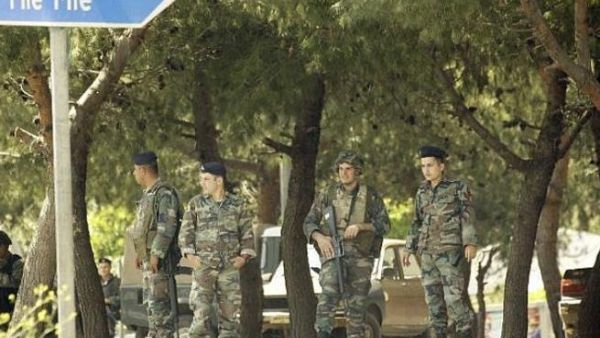 Soldiers stand guard on the road leading to Mieh Mieh Palestinian refugee camp. (AFP/ File Photo)