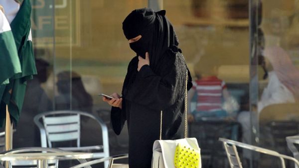 A Saudi woman looks at her mobile phone in the capital Riyadh (AFP Photo)