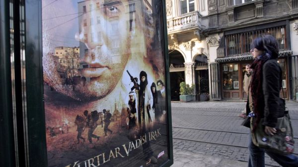 Woman passes by 'Turkish James Bond' film poster. (AFP/ File)