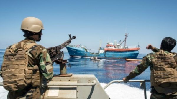 Libyan coastguards stand on an armoured boat as they patrol the sea off Libya's western coast. (AFP/File)