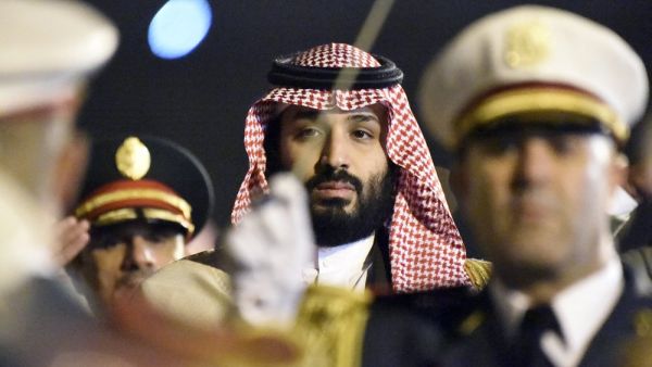 Crown Prince Mohammed bin Salman is seen behind a military band upon his arrival at Algiers International Airport on Dec. 2, 2018. (AFP / RYAD KRAMDI)