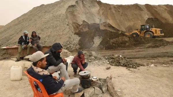 Unemployed Tunisians sit at a phosphate production plant in Kef Eddour. (AFP)