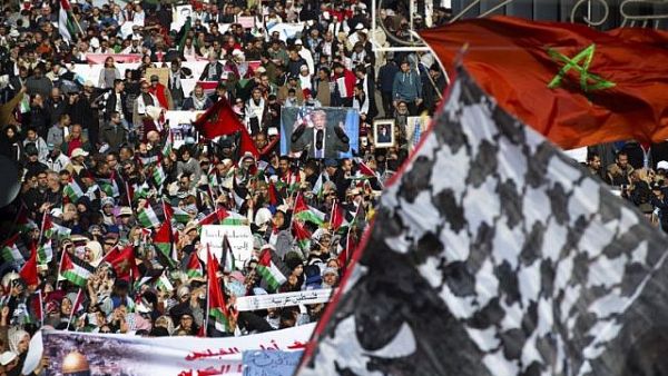 Pro-Palestinian protesters wave Palestinian and Moroccan flags during a demonstration in Rabat. (AFP/ File Photo)