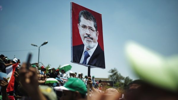 Protesters holding a picture of ousted President Morsi in Cairo during a demonstration. (AFP/File)
