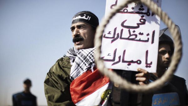 Protestors at Mubarak's sentencing in 2012. The sign reads, "this rope is waiting for you Mubarak." (AFP/File)