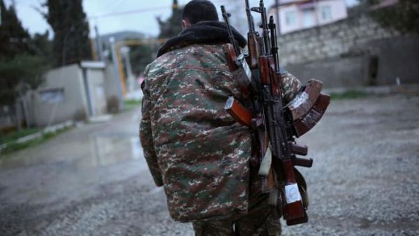 A soldier of the self-defense army of Nagorno-Karabakh carries weapons in Martakert. (AFP/File)