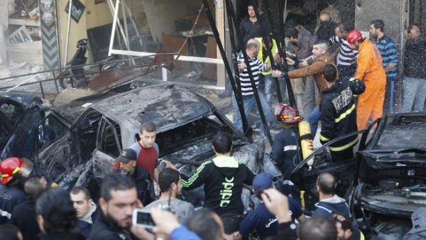 Rescue teams and local residents gather at the scene of a car bomb explosion in Beirut's southern suburb of Haret Hreik on January 21, 2014. [AFP]