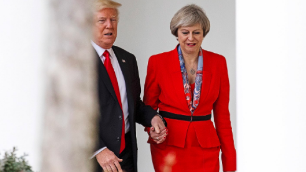 Donald Trump and Theresa May hold hands as they stroll in the White House in a January 2017 visit by the British Prime Minister to Washington. (AFP/Getty Images) 