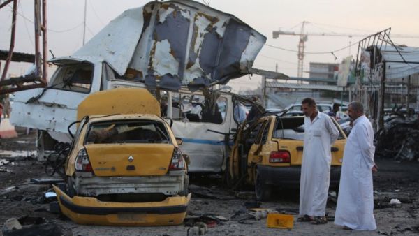 Two men inspect the site of a car bomb that went off in the mostly Shia Sadr City district of Baghdad on October 13, 2014. (AFP/Ahmad al-Rubaye) Two men inspect the site of a car bomb that went off in the mostly Shia Sadr City district of Baghdad on October 13, 2014. (AFP/Ahmad al-Rubaye)
