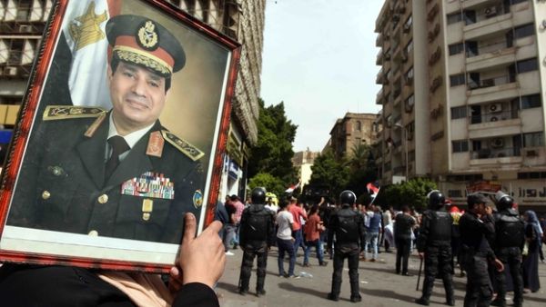 A supporter of President Abdel Fattah al-Sisi carries of portrait of the Egyptian leader. (AFP/File)
