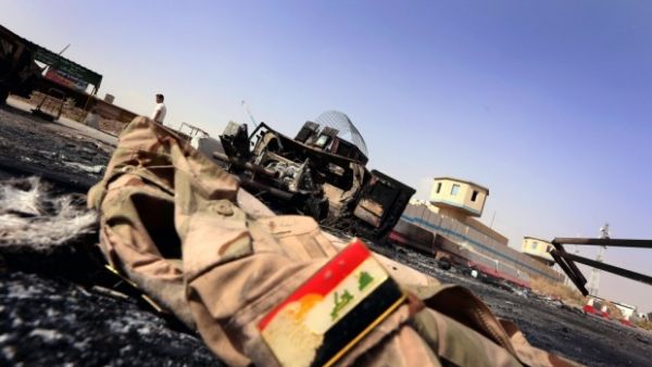 Jacket belonging to an Iraqi Army uniform lies on the ground in some 10km of east of Mosul. (AFP/File)