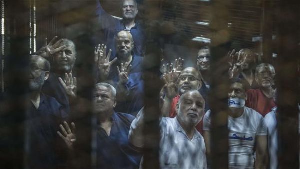 Senior figures of Egypt’s Muslim Brotherhood gesture from the defendants cage during their trial at the police academy on the outskirts of Cairo on June 2, 2015. (AFP/File)