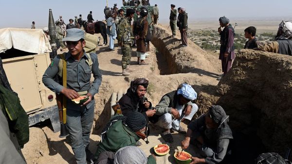 Anti-Taliban armed Afghan fighters eat watermelons on their outpost on a hilltop during a patrol against Taliban insurgents at Qara Ghoily in Almar district of northern Faryab province in this photo taken on Oct 16, 2015. (AFP/File)