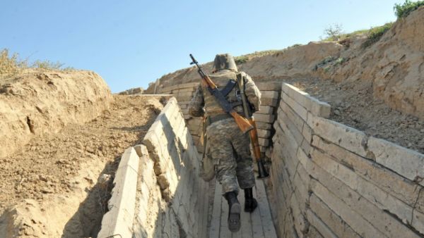Armenian soldiers run in trenches at the frontline on the border with Azerbaijan, on October 25, 2012. (AFP/Karen Minasyan)