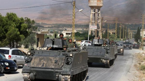 Lebanese army soldiers drive armoured personnel carriers in the northern Lebanese town of Arsal on the border with Syria on August 6, 2014. (AFP/File)