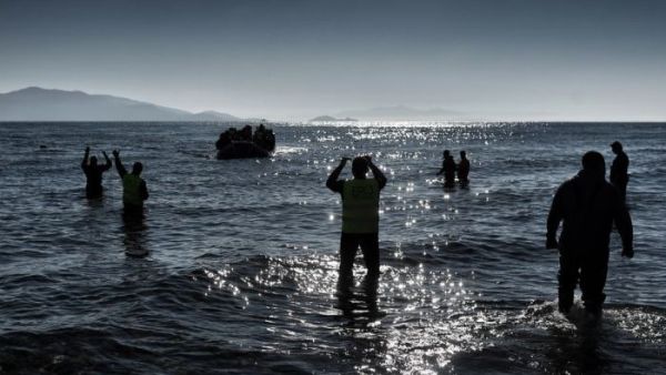A boat carrying refugees and migrants arrives on a Greek island, after crossing the Aegean sea from Turkey in February. (AFP/Aris Messinis)