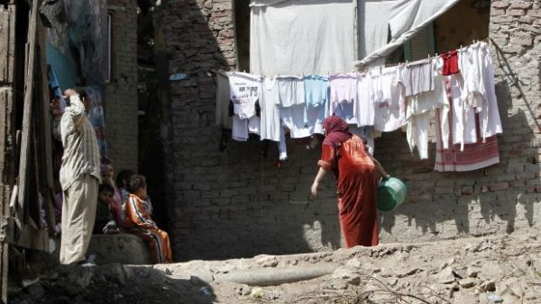 Members of an Egyptian family gather outside their house in a Cairo slum. (AFP/File)