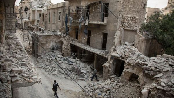 A Syrian man walks past destroyed buildings on May 2, 2016, in Aleppo. (AFP/File) A Syrian man walks past destroyed buildings on May 2, 2016, in Aleppo. (AFP/File)
