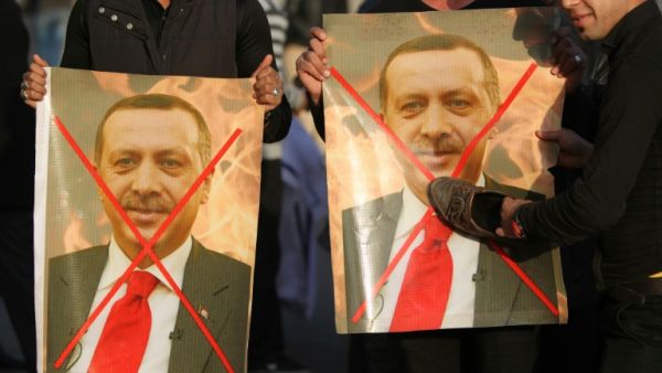 Iraqis hold crossed-out portraits of Turkey's President Recep Tayyip Erdogan during a December 2015 demonstration to demand the withdrawal of Turkish forces from Iraq. (AFP/Ahmad Al-Rubaye)
