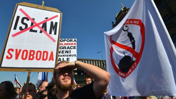 Protesters hold banners and Czech national flags during an anti-refugee rally on September 12, 2015 in Prague. (AFP/Michal Cizek)