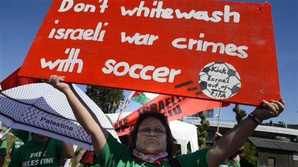 Demonstrators call for the expulsion of Israel from FIFA during a protest rally prior to the opening of the 65th FIFA Congress in Zurich, Switzerland. (AFP/File)