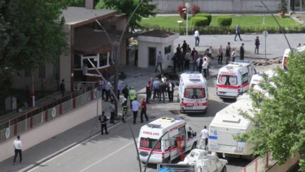 People inspecting the remains of the bombed out car outside Gaziantep police station. (AFP/File)
