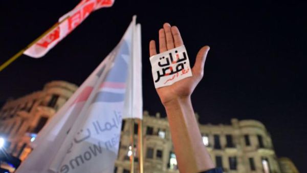 An Egyptian protester hold up his hand with a slogan reading in Arabic: “Egyptian girls are a red line” during a demonstration in Cairo against sexual harassment on 12 February 2013. (AFP/Khaled Desouki)