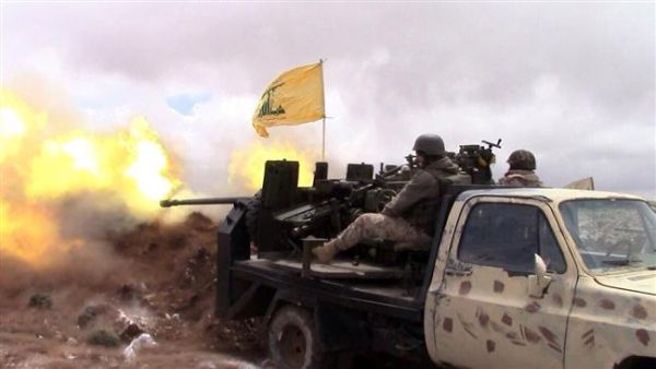 A handout picture released by the Hezbollah press office on May 16, 2015, shows a Hezbollah fighter firing towards militants on the Syrian side of the Qalamoun hills close to the Lebanese border. (AFP/File)