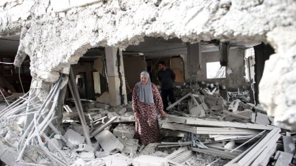 A Palestinian woman walks amid the rubble of a house after Israeli security forces demolished the home of her family. (Twitter)