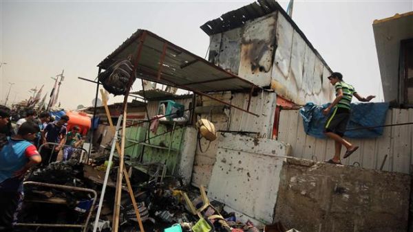 This May 11, 2016 photo shows people looking at the damage following a car bomb in Baghdad. (AFP/File)