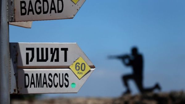 A sculpture of an Israeli soldier standing guard is seen next to a sign for tourists. (AFP/File)