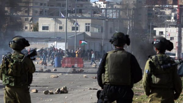 Israeli soldiers look on during a crackdown on Palestinian Birzeit University students outside the Ofer prison near Ramallah on 13 February 2012. (AFP/File)