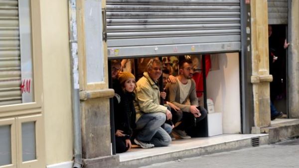 Residents find a safe space inside of one of the city's stores after the explosion. (AFP/Bulent Kilic)