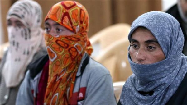 Izadi women look on at al-Tun Kopri health centre, located half way between the northern Iraqi city of Kirkuk and Arbil, after ISIL released them with around 200 mostly elderly members of Iraq's Izadi minority near Kirkuk on January 17, 2015. (AFP/File)
