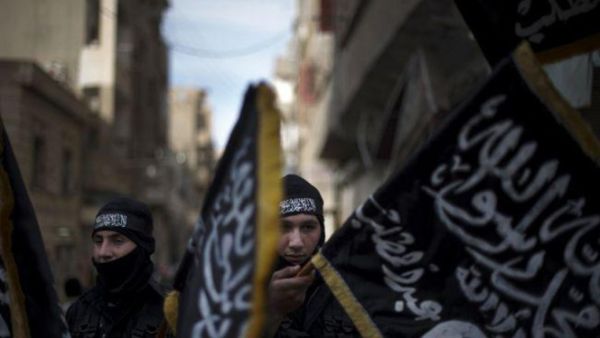 Members of Liwa Hamzah, a newly formed Islamist brigade from the Syrian eastern city of Deir Ezzor, hold flags of Jabhat Al-Nusra on Feb. 25, 2013. (AFP/File)