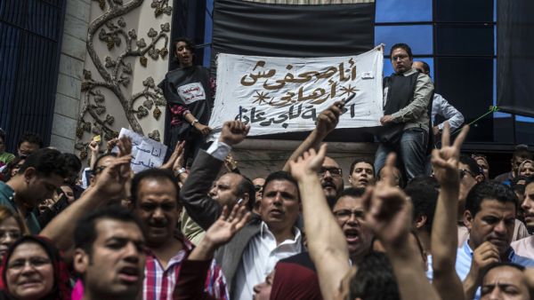 Journalists hold a banner reading in Arabic: "I am a journalist not a terrorist". (AFP/File)