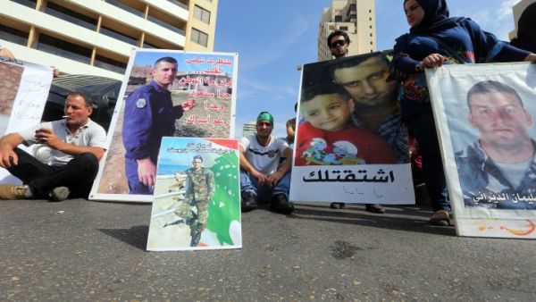 Relatives of Lebanese soldiers and policemen being held hostage by jihadists in Syria, hold portraits during a protest to press for their release. (AFP/Joseph Eid)