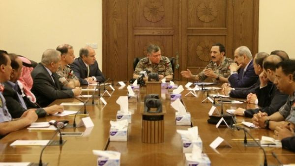 Jordan's King Abdullah II (C) listens to his Military Advisor and Chairman of the Joint Chief-of-Staff General Mishal Al Zaben (C-R) talking during an emergency meeting in the capital Amman after a car bomb on June 21, 2016. (Jordanian Royal Palace/AFP/Yousef Allan)