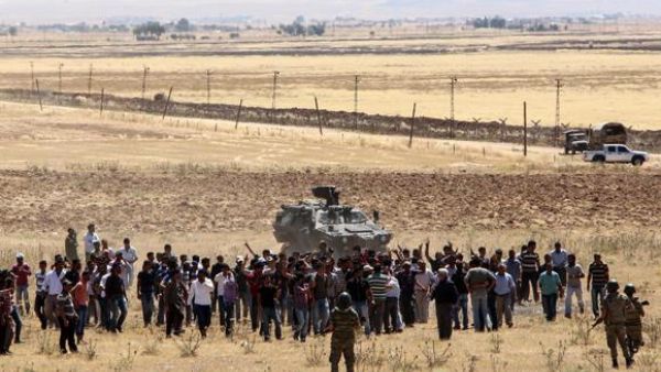 Turkish Kurds gather in Suruc in Sanliurfa province on the Turkish-Syrian border to show support for the people of the Syrian town of Kobane on Thursday. (AFP/File)
