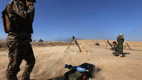 Iraqi Kurdish Peshmerga fighters fire a mortar shell from the top of Mount Zardak, about 25 kilometres east of Mosul. (AFP/File)