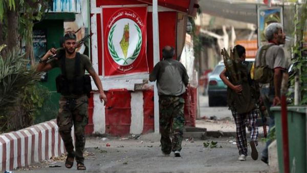 Armed men walk in the streets of Ain al-Hilweh Palestinian refugee camp near Lebanon's southern port city of Sidon following clashes on August 22, 2015. (AFP/File)
