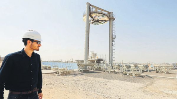 An employee walks at a solar plant in Masdar outside the Emirate of Abu Dhabi. (AFP/File)