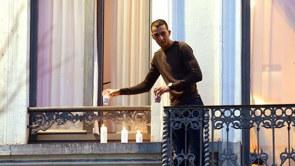 Mohamed, brother of the two suspected extremists responsible for the Paris attacks, placing lit candles on the balcony of his home during a vigil for the Paris victims. (AFP/File)