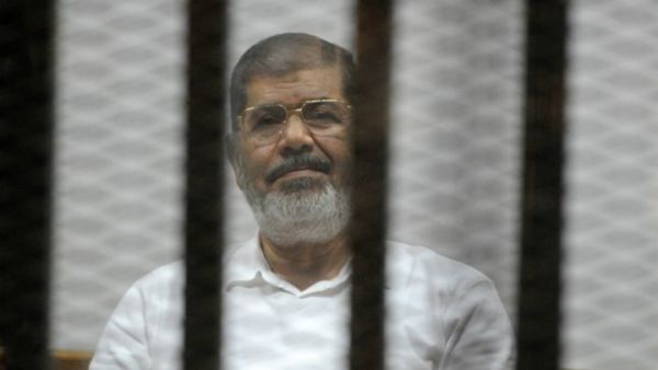 Egypt's deposed president Morsi sits behind the defendants cage during a court trial in Cairo on November 5, 2014. (AFP/File) 