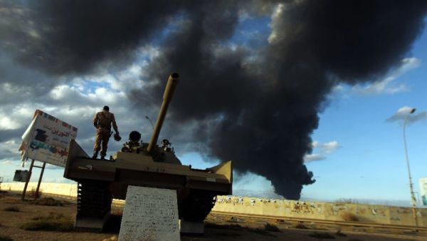 A member of the Libyan army stands on a tank. (AFP/File)