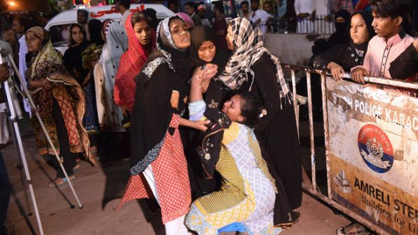 Pakistani women mourn the death of relative outside of a mortuary in Karachi on Saturday, following a suicide bombing at a Sufi shrine. (AFP/File)