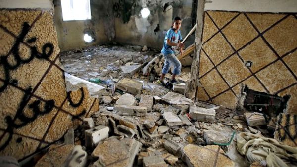 A Palestinian walks through a destroyed home in Silwan after it was razed by Israeli authorities in March. (AFP/Ahmad Gharabli)