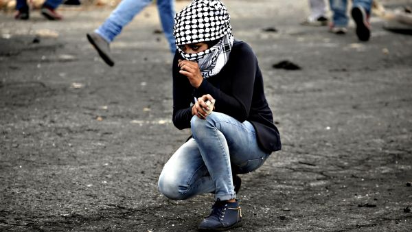 A Palestinian young woman from the Birzeit University looks on during clashes with Israeli security forces. (AFP/File)